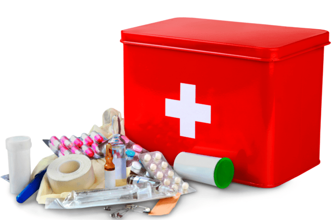 Red first aid kit with essential items displayed outside the kit