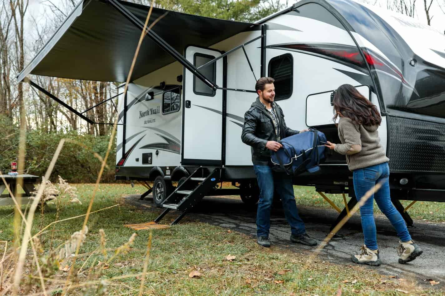 Couple packing an RV for National Camping Month