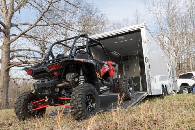 an ATV being rolled out of a toy hauler