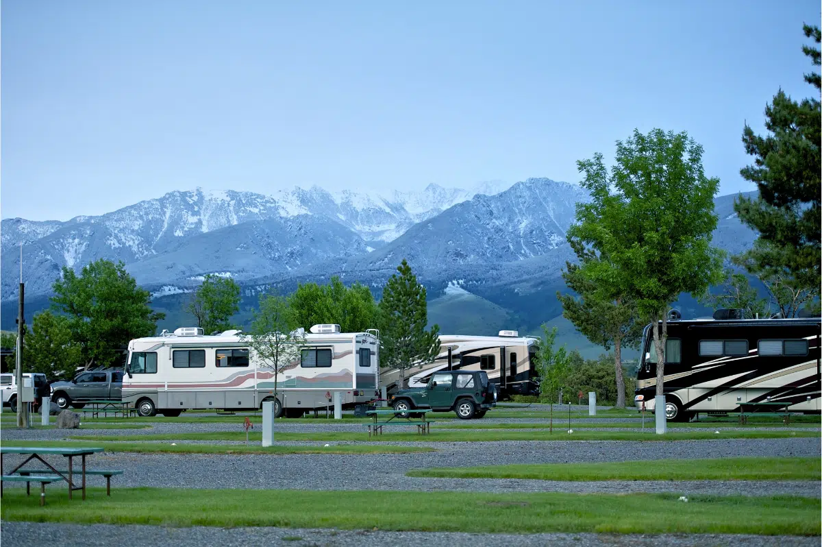 A Class A at an RV park with a Jeep attached to the tow bar