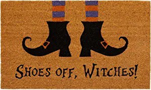 A doormat that reads “Shoes off, Witches!”
