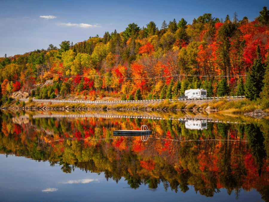 An RV rental traveling through the fall foliage. 