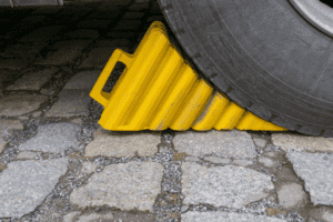 A plastic wheel chock securing a tire