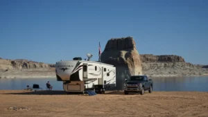 A fifth wheel trailer on a beach