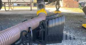 An RV sewer hose on an RV sewer hose support