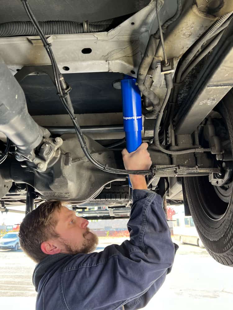 Shocks being installed on a Class C RV.