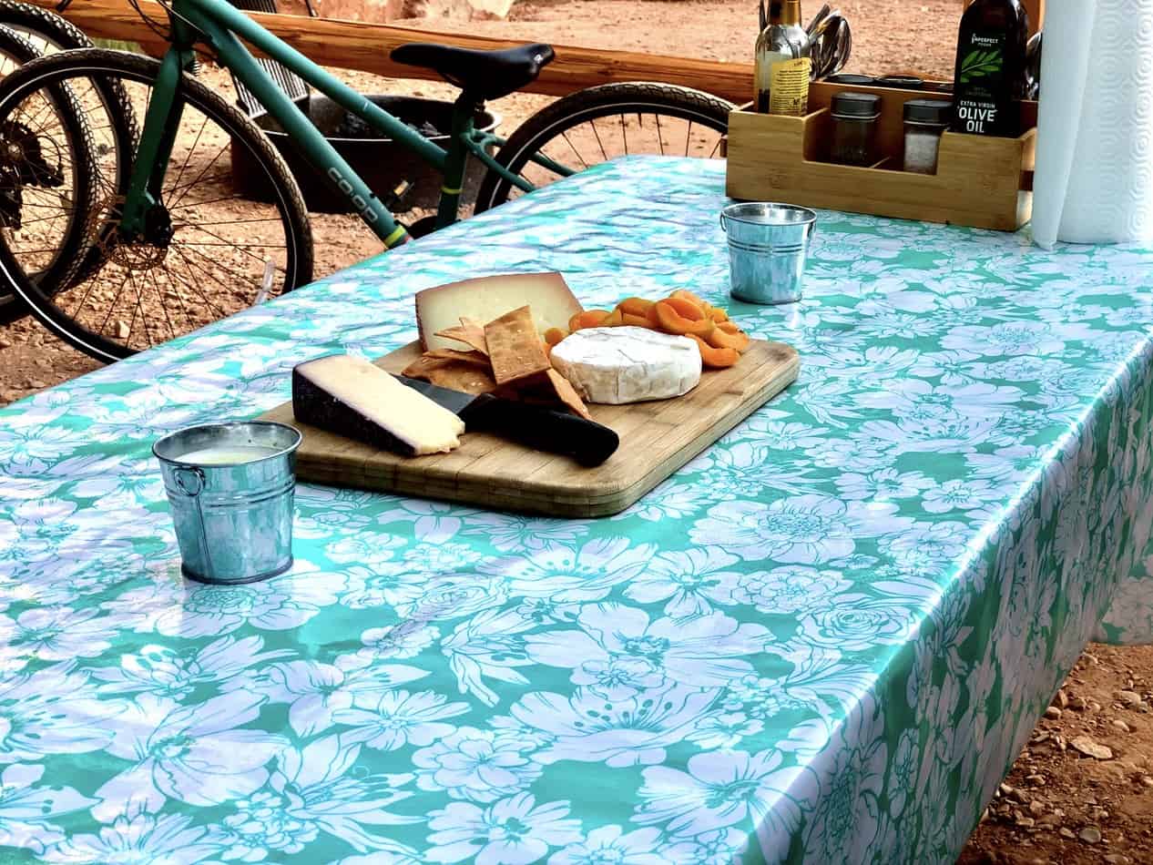 Picnic table on campsite covered for cooking in the outdoors