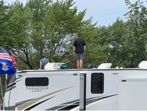 man standing on an RV roof