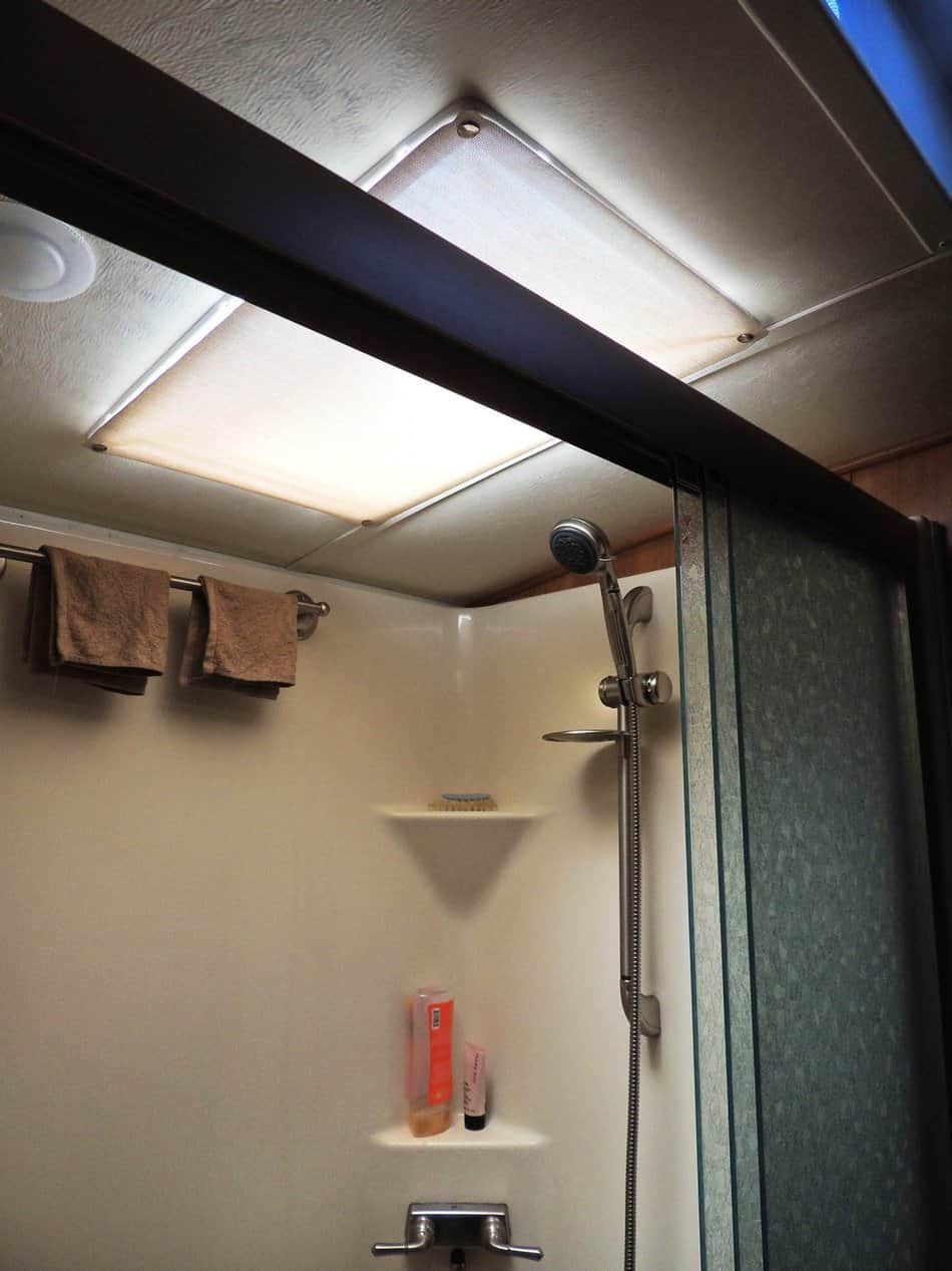 RV shower skylight with white fabric snapped to the skylight interior for shade.