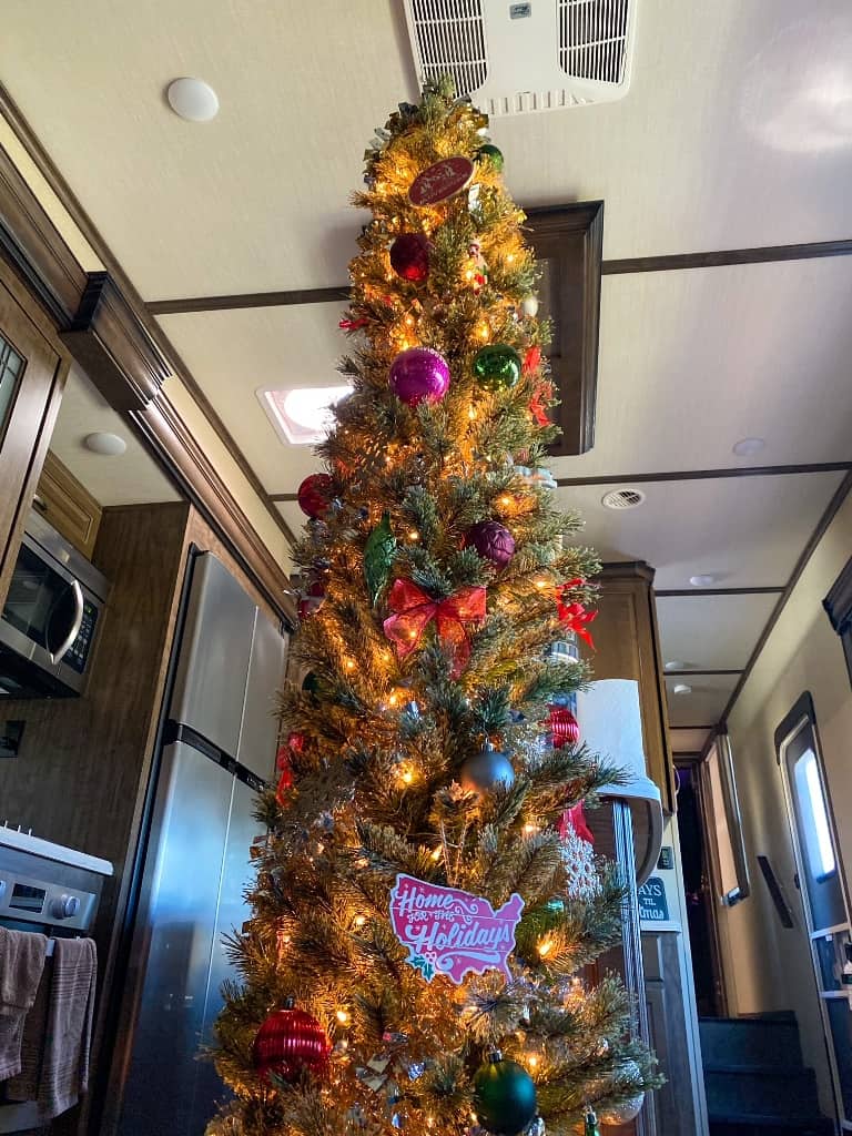 a smart RV decorating idea is a tall and skinny Christmas tree that doesn't take much space like this one