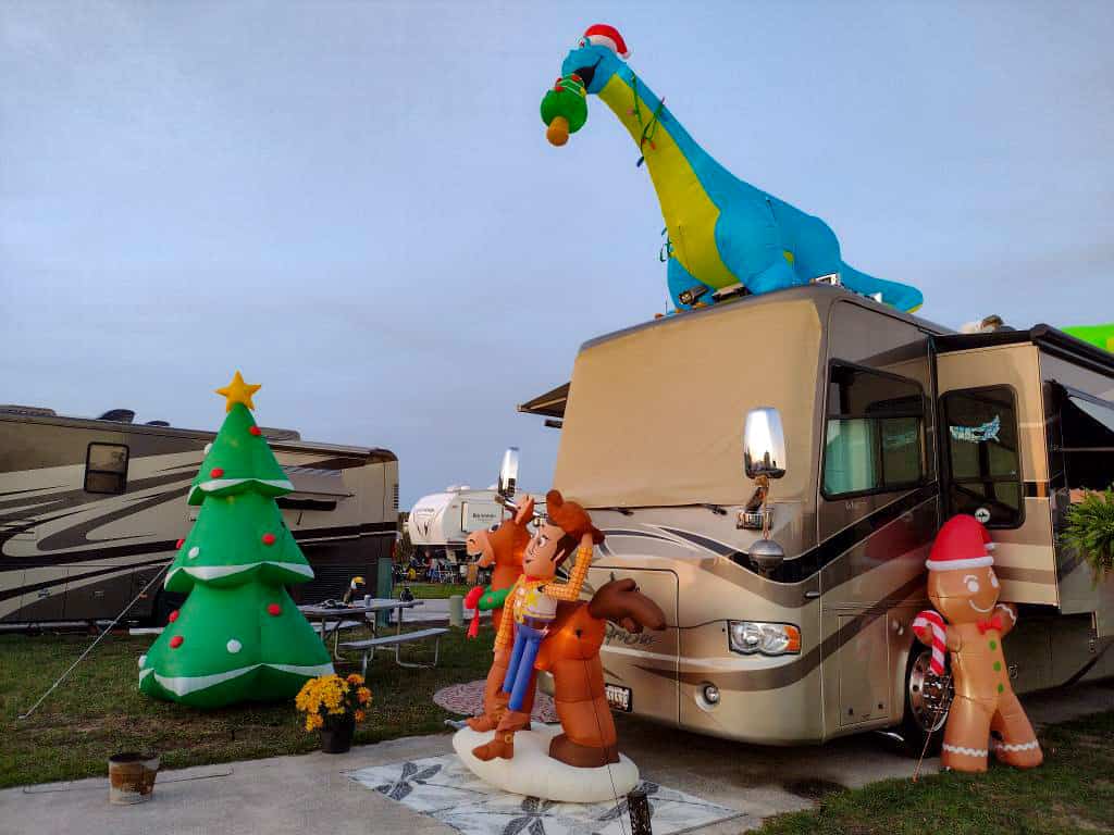 holiday themed  inflatables like a Christmas tree and gingerbread man set up outside the RV