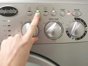 Woman Pressing Button On RV Washer Dryer Combo