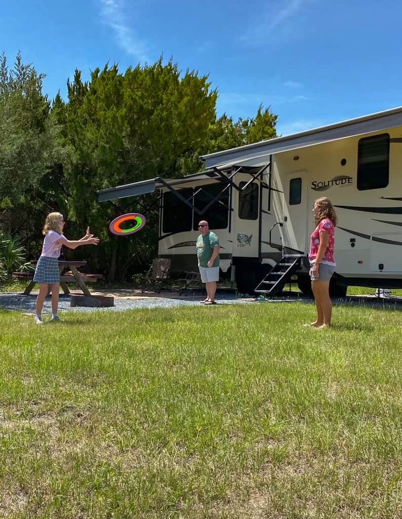 Family RVing And Playing Catch In Campsite