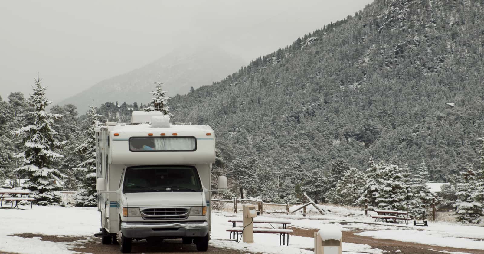 RV parked in deserted RV campsite in snow at Estes park, Colorado.