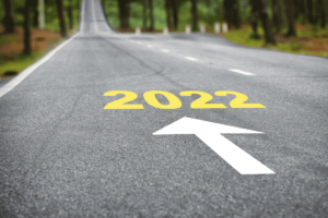 2022 painted on a road with an arrow going forward