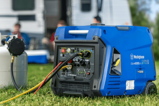 Blue generator connected to a propane tank with an RV and people in the background