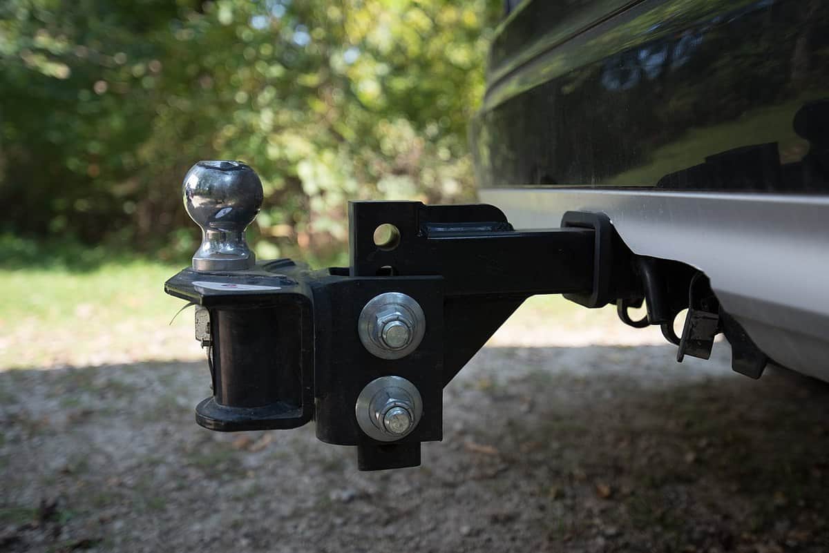 An adjustable ball hitch on the back of a vehicle