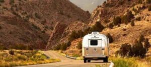 Airstream RV being driven down a winding road