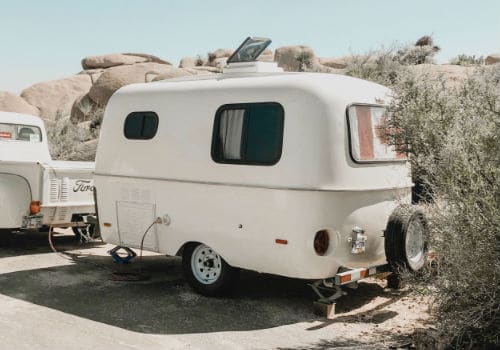 Small Scamp travel trailer parked in a desert setting