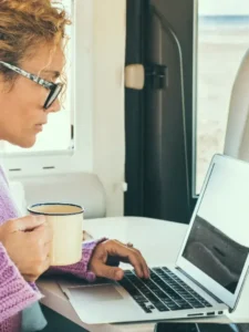 Woman surfing the internet inside her RV