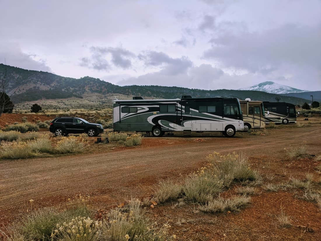 Row of Class A motorhomes sitting at Indian Peaks RV Park