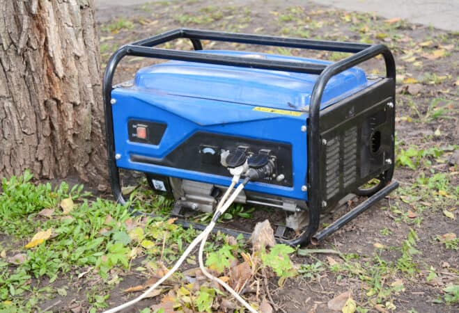 blue generator sitting in the grass
