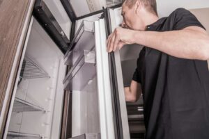 Man opening an RV fridge door