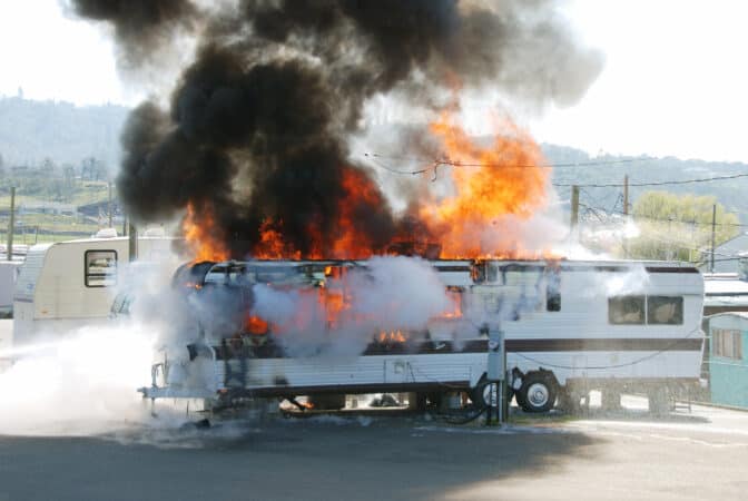 A travel trailer RV on fire